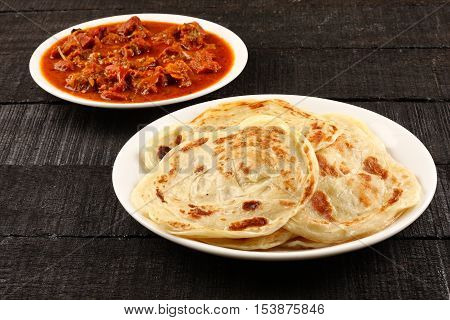 Indian street food -Paratha with spicy and tasty mutton curry.