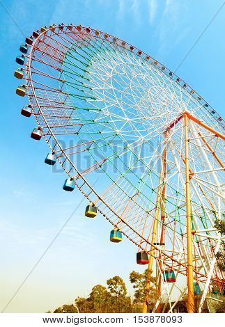 Ferris wheel with tourists flying in the air.