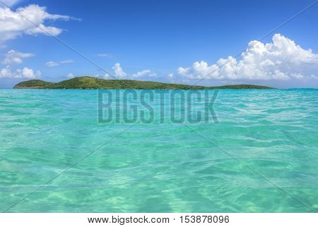 Unpopulated North Cay with green vegetation and shallow turquoise water of Zoni Beach on Isla Culebra on beautiful sunny day