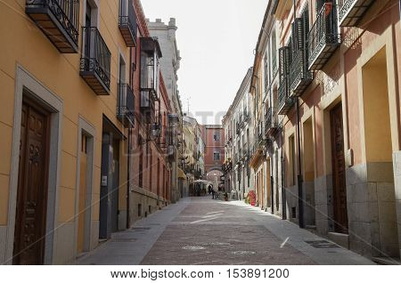 View narrow old street near market square of medieval Avila town. Castile and Leon Spain