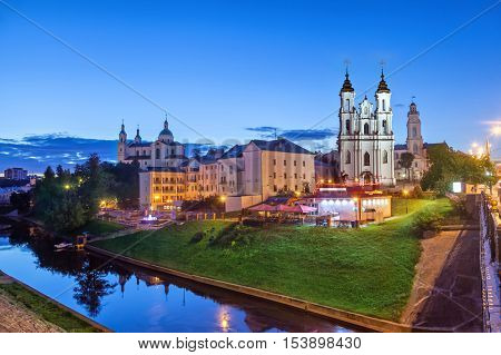 Resurrection church and buildings on the side of Vitba river in the evening Vitebsk Belarus