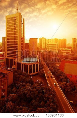 Dusk modern city high-rise building and road.