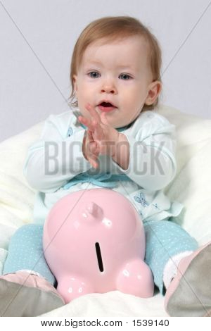 Child Holding Piggy Bank And Claping Hands