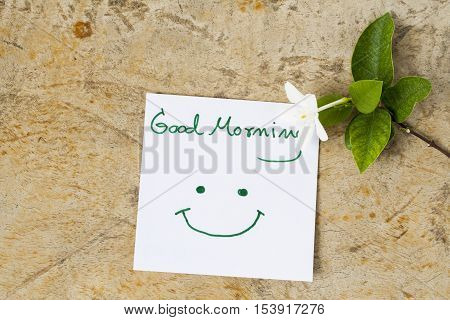 good morning message card greeting and white flowers on background old wood