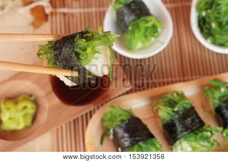 Sushi roll and seaweed salad is delicious