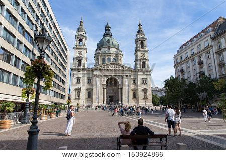 Budapest, Hungary - September 29, 2016. Tourist couple admiring the views of the Cathedral of St. Stephen. Groups of tourists looking at the Cathedral of St. Stephen. St. Stephen's Basilica Budapest.