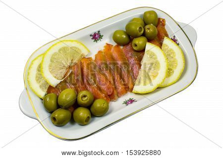 Balyk of a humpback salmon with olives and a lemon isolated on a white background