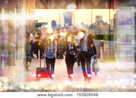 Business people walking in the City, blurred image with lights reflection. Business and modern life concept
