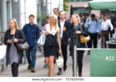 Business people walking in the City, blurred image with lights reflection. Business and modern life concept