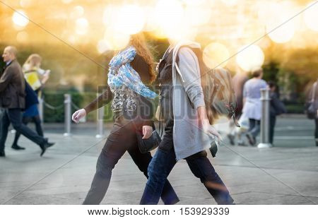 Business people walking in the City, blurred image with lights reflection. Business and modern life concept