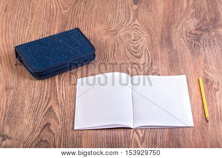 School supplies on the wooden background .