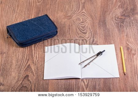 School supplies on the wooden background .