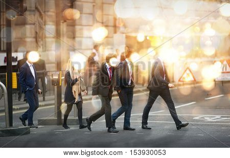 Business people walking in the City, blurred image with lights reflection. Business and modern life concept