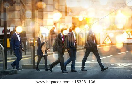 Business people walking in the City, blurred image with lights reflection. Business and modern life concept