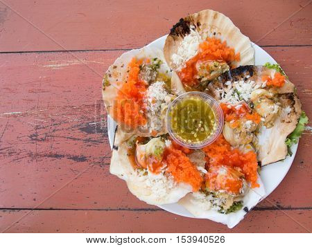 Grilled scallop placed on wooden table background