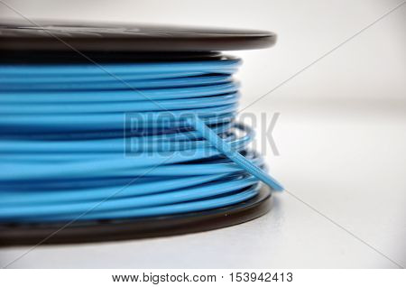 Blue 3d printing filament plastic spool on table