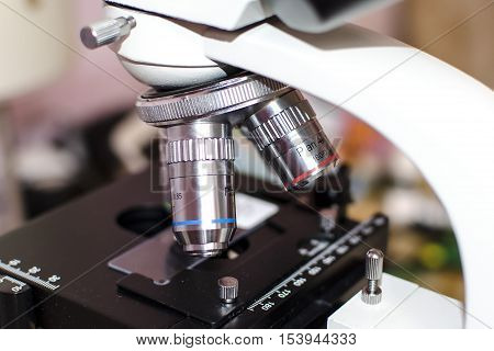 Laboratory microscope. Close-up view of objective lenses and stage with microslide