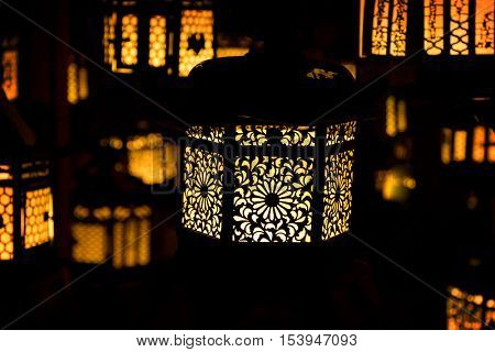 Japanese Temple Lanterns. Suspended temple lanterns with intricate  bokeh, dark, decorative openwork designs, in Nara, Japan. 