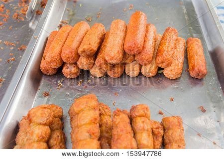 grilled sausages and vegetables in black dish,dark tone