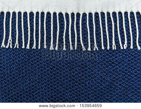 Blue knited background with white fringe.Hand Made.Top view