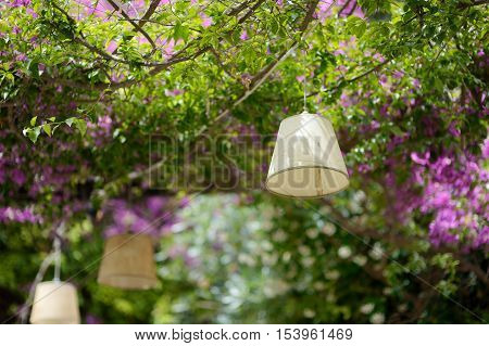 A Lamp Hanging Above Summer Outdoor Cafe