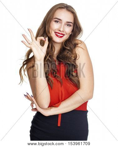 Portrait of a beautiful young brunette woman showing okey, isolated on white background