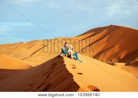 Loving couple in the Sahara Desert. Morocco.