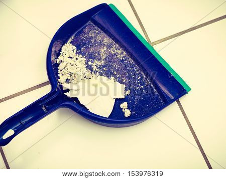 Scoop hygene chores housework tidying sweeping concept. Dust pan with garbage. Sweeping tool with dirt.