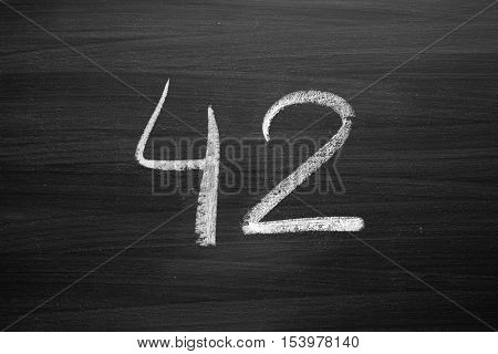 number forty two enumeration written with a chalk on the blackboard