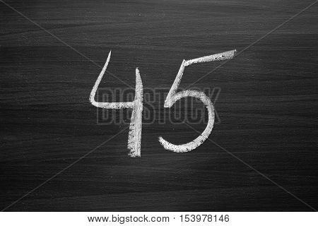 number forty five enumeration written with a chalk on the blackboard