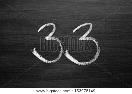 number thirty three enumeration written with a chalk on the blackboard