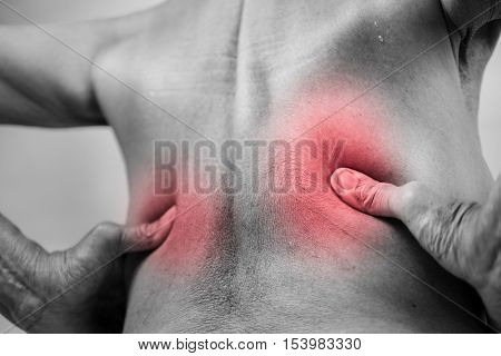 senior man hand holding he back and massaging in pain area. Concept with Healthcare And Medicine.