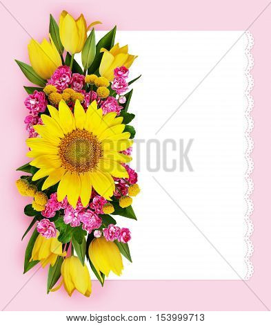 Sunflower tulips and hawtorn flowers arrangement and a card on pink background