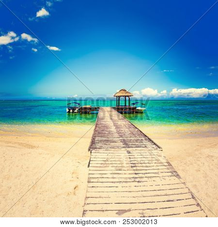Sandy tropical Wolmar beach at sunny day. Jetty on the foreground.  Mauritius