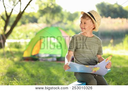 Little Boy With Map Near Tent Outdoors. Summer Camp