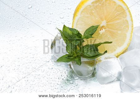 Lemon Ring With Ice And Mint On A Silvery Background Closeup
