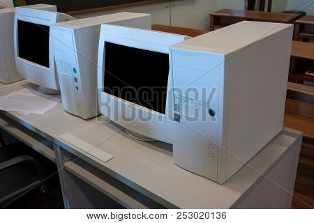 Old Crt Computer Monitors And Towers In Classroom.