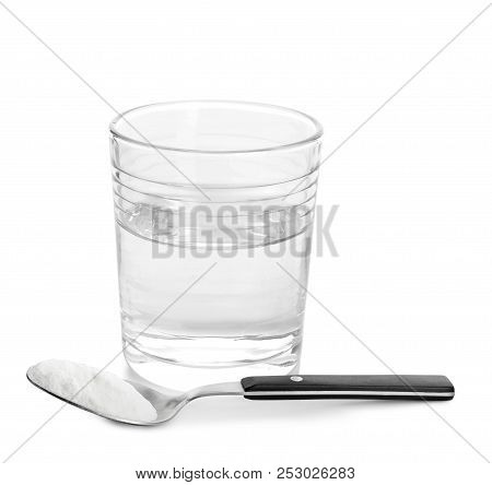 Glass Of Water And Spoon With Baking Soda On White Background