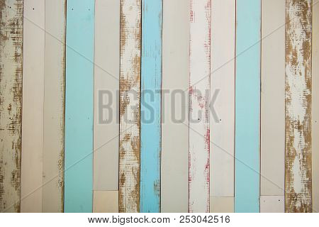 Wall Made Of Multi-colored Wooden Boards. Abstract Grunge Wood Texture Background