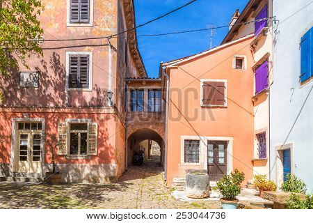 Ancient Colorful Houses On A Stone Street In Groznjan Village, Istria, Croatia, Europe.