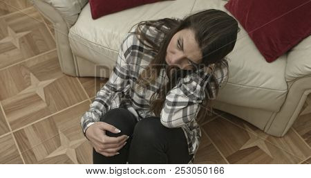 Depressed young woman at home. Camera dollies schoot.
