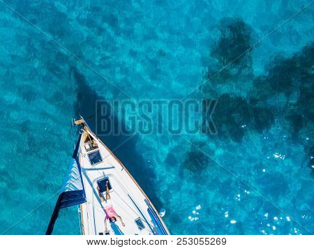 Amasing Aerial View To Yacht In Deep Blue Sea With Relaxing Woman. Drone Photography