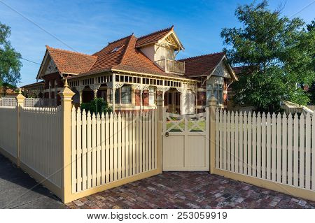 Melbourne, Australia - February 17, 2018: A Brick Heritage Home With A White Wooden Picket Fence In 