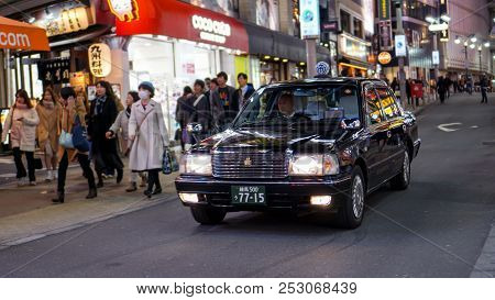 Shibuya, Tokyo / Japan - March 02, 2018: A Black Taxi Looking For A Passenger Along The Streets Of T