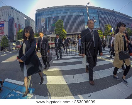 Fukuoka, Japan - April 27, 2016: Japanese Working People Crossing The Road In The Busy Day In Front 