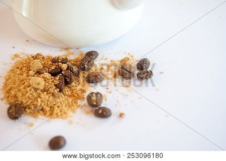 Roasted Coffee Beans Mixed With Brown Sugar Near Enamel Pot On White Background