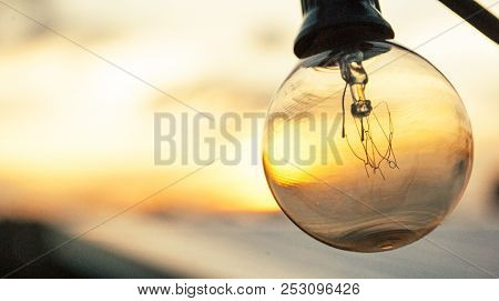 Light Bulb Stands Out From Beautiful Sunset Background