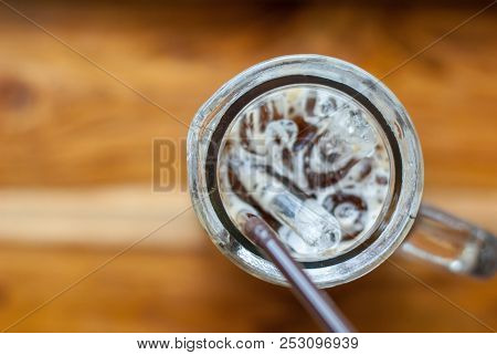 An Iced Espresso Coffee In Tall-shape Glass With Brown Plastic Straw In The Right Side Of Photo Focu