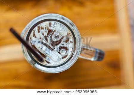 An Iced Espresso Coffee In Tall-shape Glass With Brown Plastic Straw In The Left Side Of Photo Focus