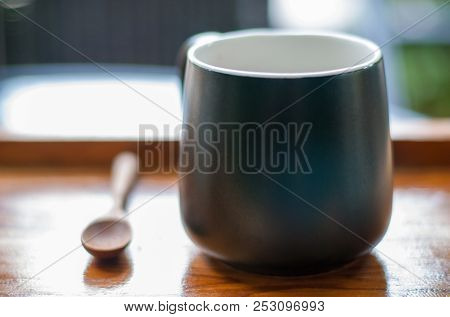 Black Hot Espresso Coffee Mug Is Placed Together With Brown Wooden Spoon In Tray In Coffee Cafe In O